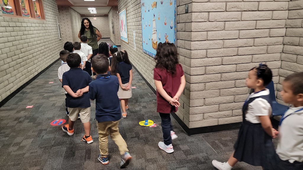 Students walking in the hallway with their teacher