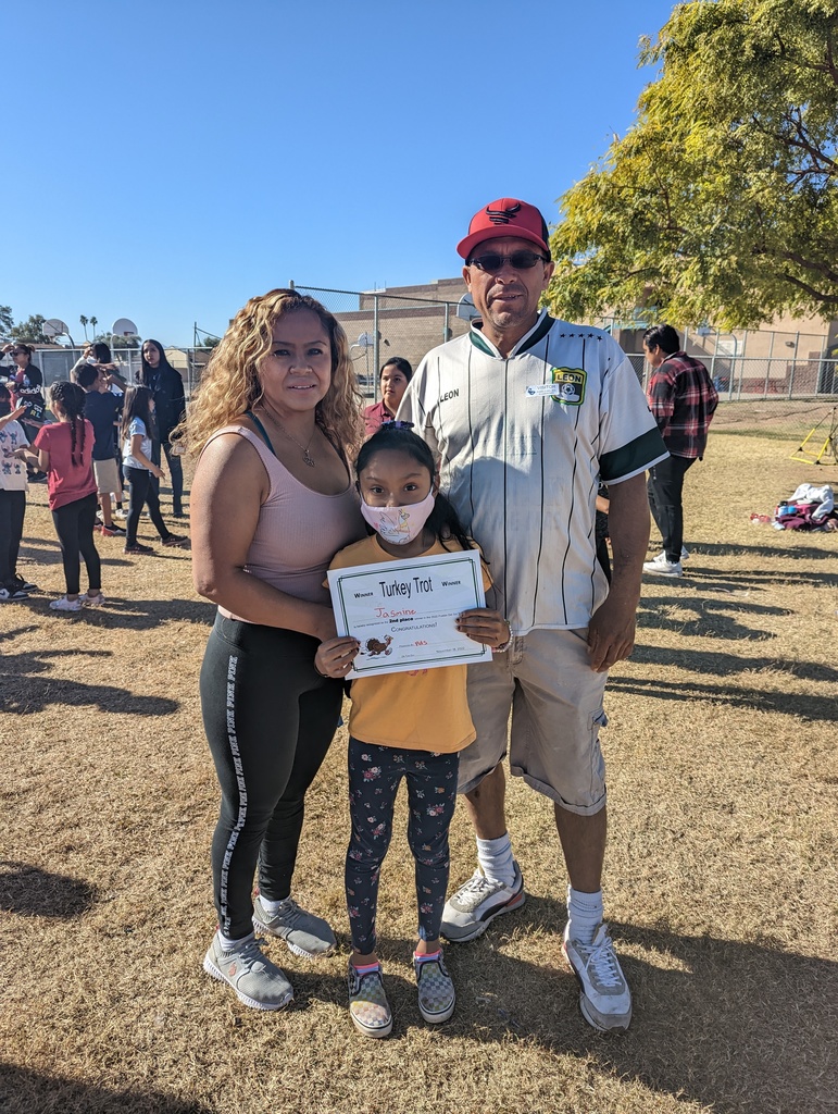 Mother, father, and daughter with a certificate
