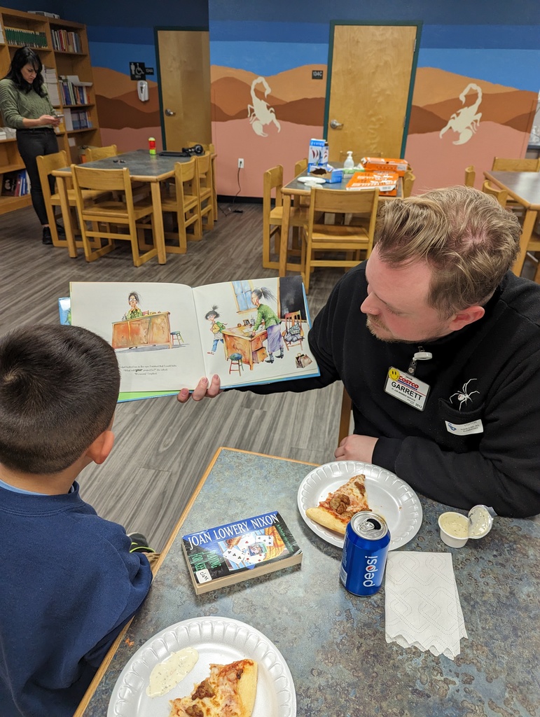 Costco reading program employee reading to children