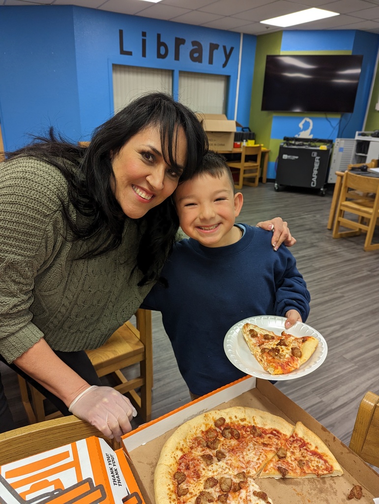 Board president and student enjoying pizza