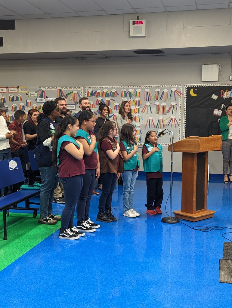 Girls scout troop reciting the pledge of allegiance