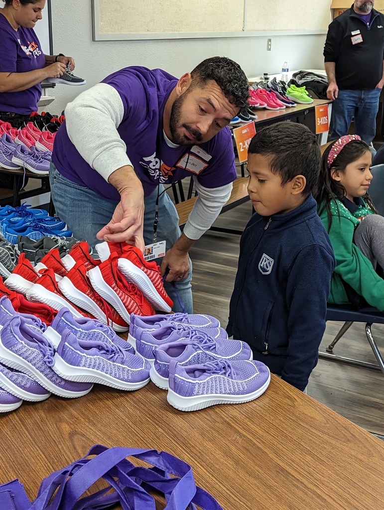 FedEx employees helping students pick out shoes