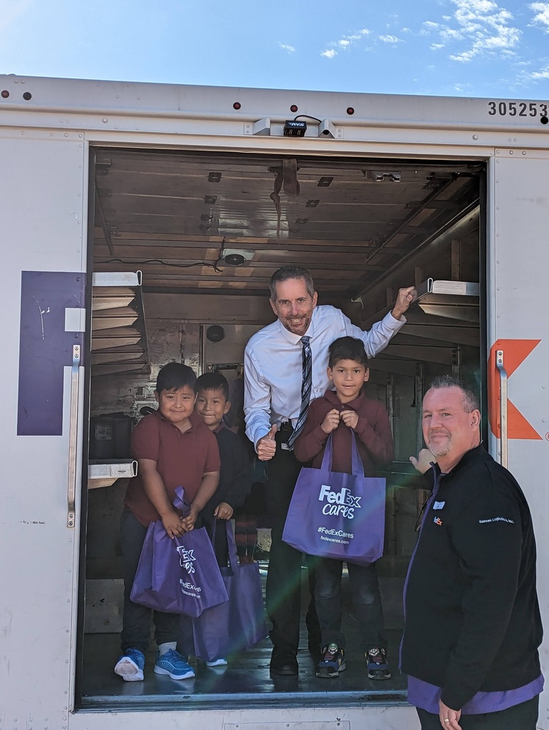 principal and students in a FedEx truck