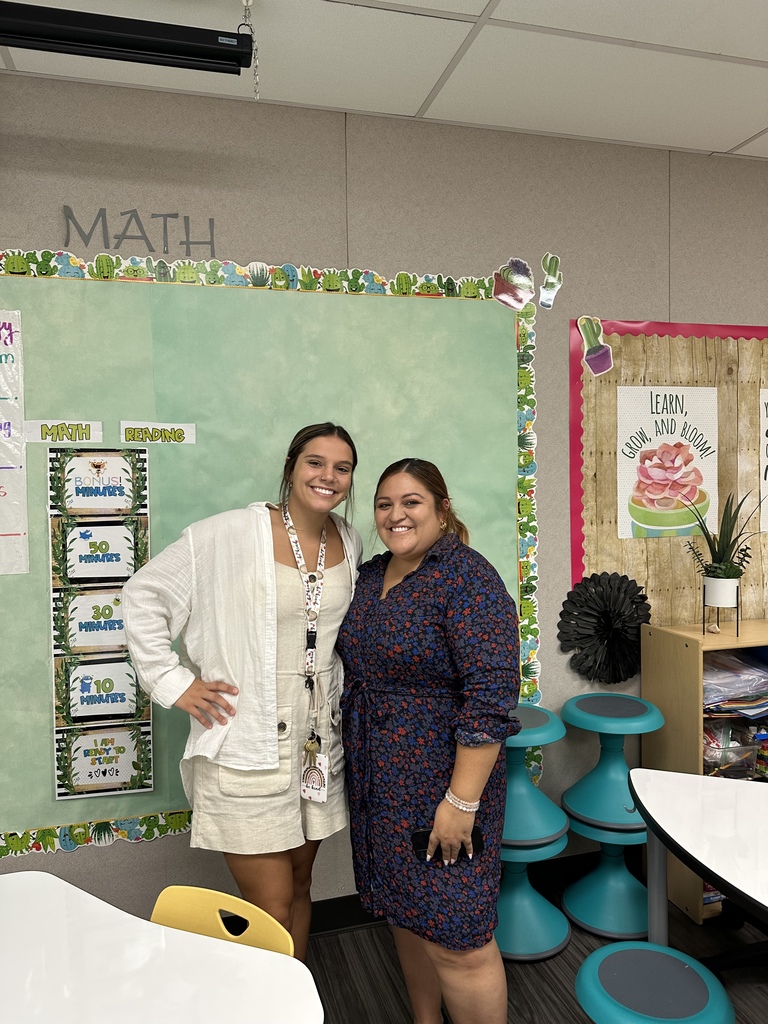Teachers with their bulletin board