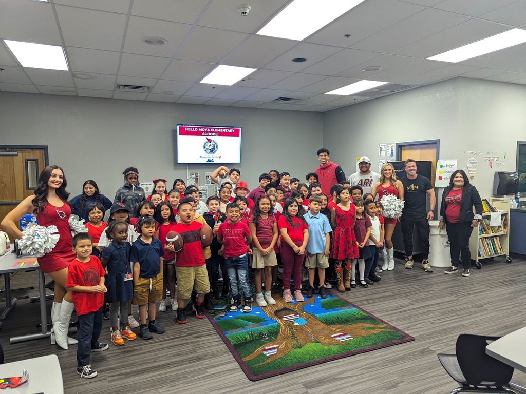 Group photo of the Arizona Cardinals, cheerleaders, students, and staff in partnership of the Milks and Cookies Reading Program