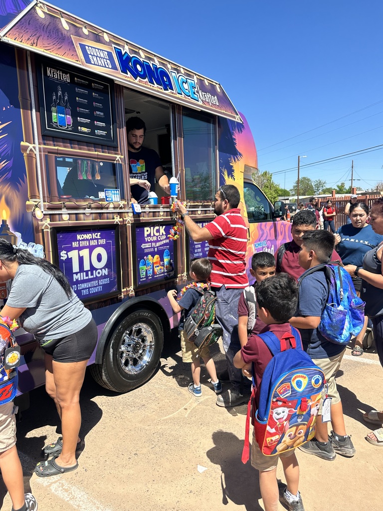 Parents and students buying from Kona Ice at school after dismissal.