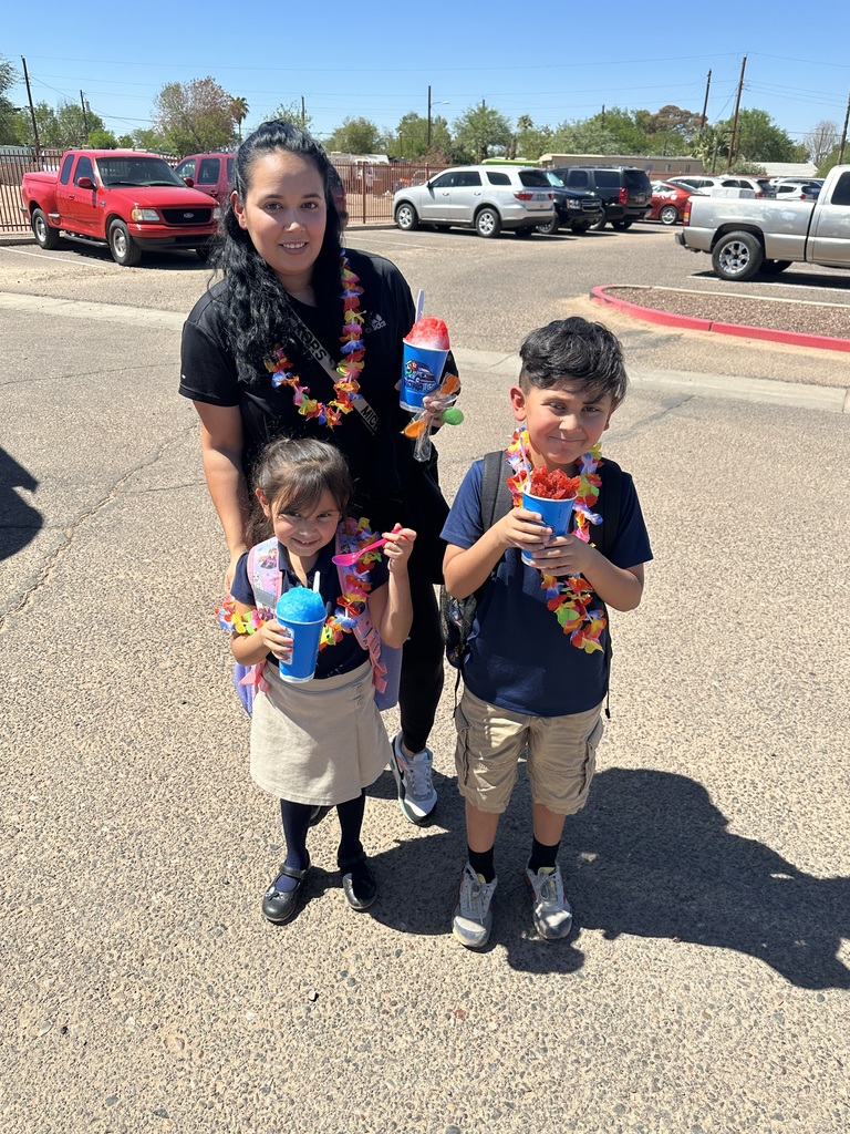 A mom and her children  with their cups of Kona Ice. 